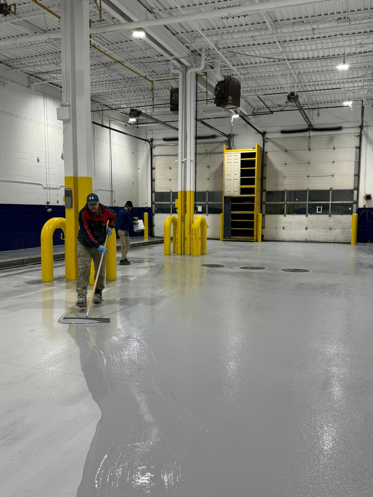 Workers applying waterproofing treatments by Albari Construction at a commercial site in Mississauga.